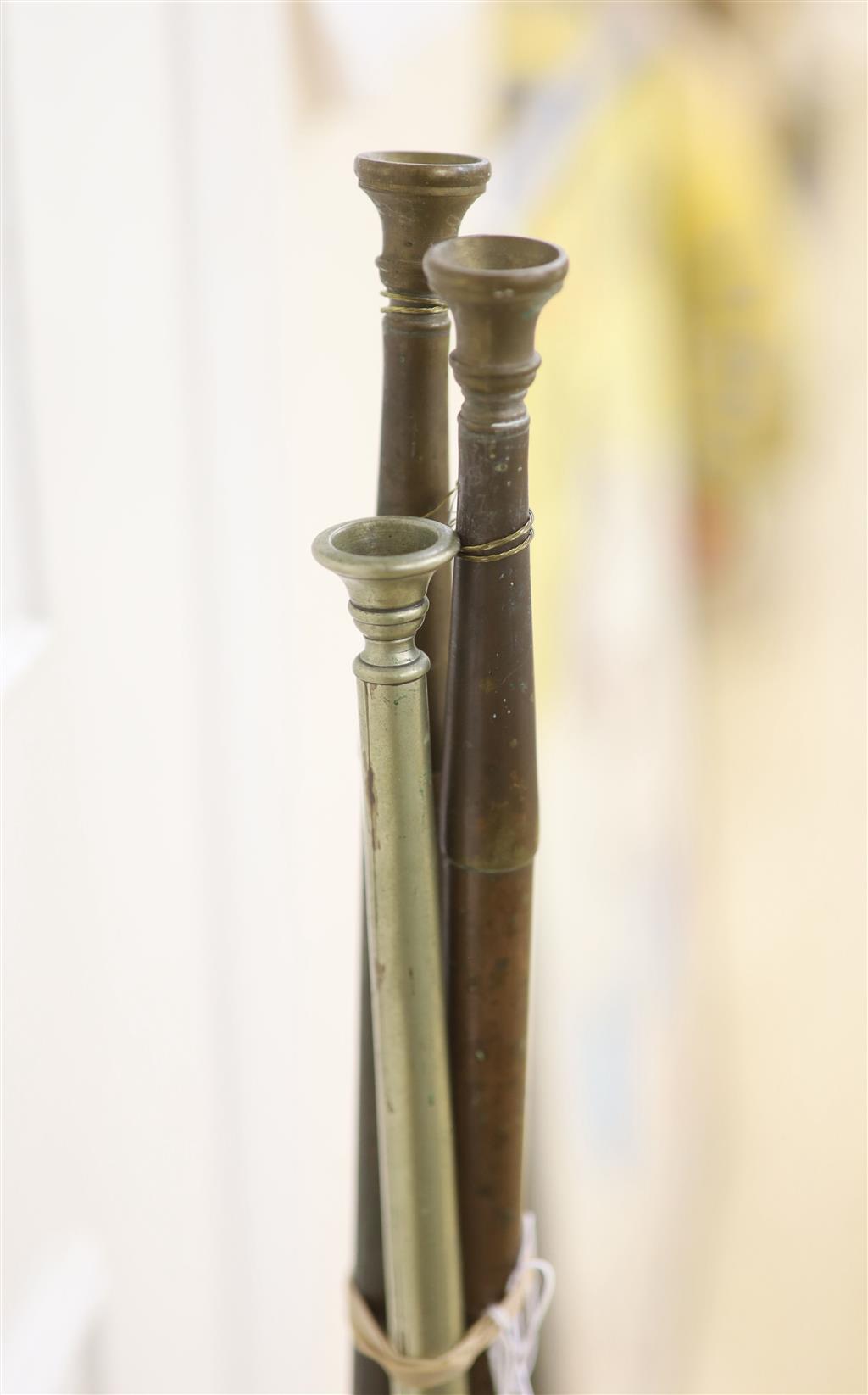 A 19th century copper coaching horn with nickel mounts, and two others, max 121cms.